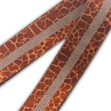 Load image into Gallery viewer, Giraffe Print long body band displayed on the ground showing the latex grip strip on the inside
